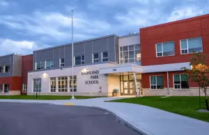Maryland Park School exterior: A modern school building with large windows, showcasing the innovative design and energy efficiency of the facility.