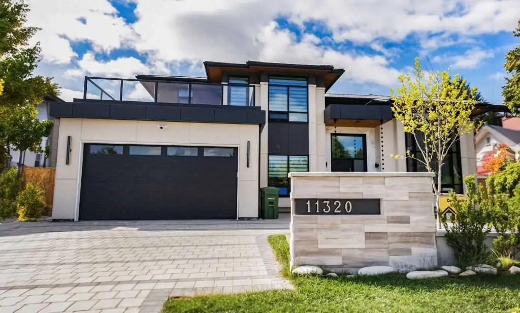 A modern home with a clean, symmetrical design and a stylish front door.