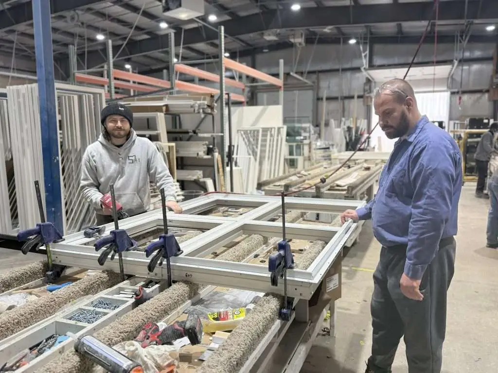 MCSC students practicing high-performance window and door assembly at the SILEX Winnipeg fabrication floor.