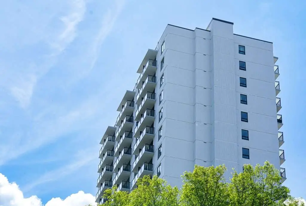 Close-up architectural detail of commercial window seals and pultruded fiberglass framing on a multi-family building envelope upgrade in BC.